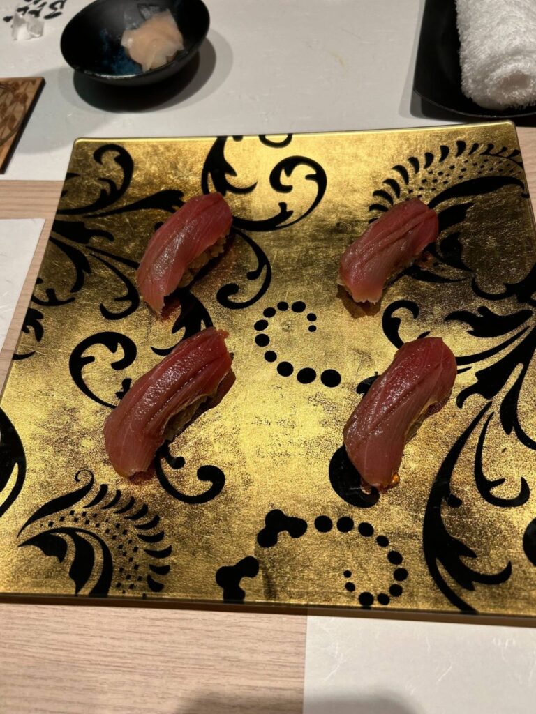 金色のお皿にのった赤身のお寿司